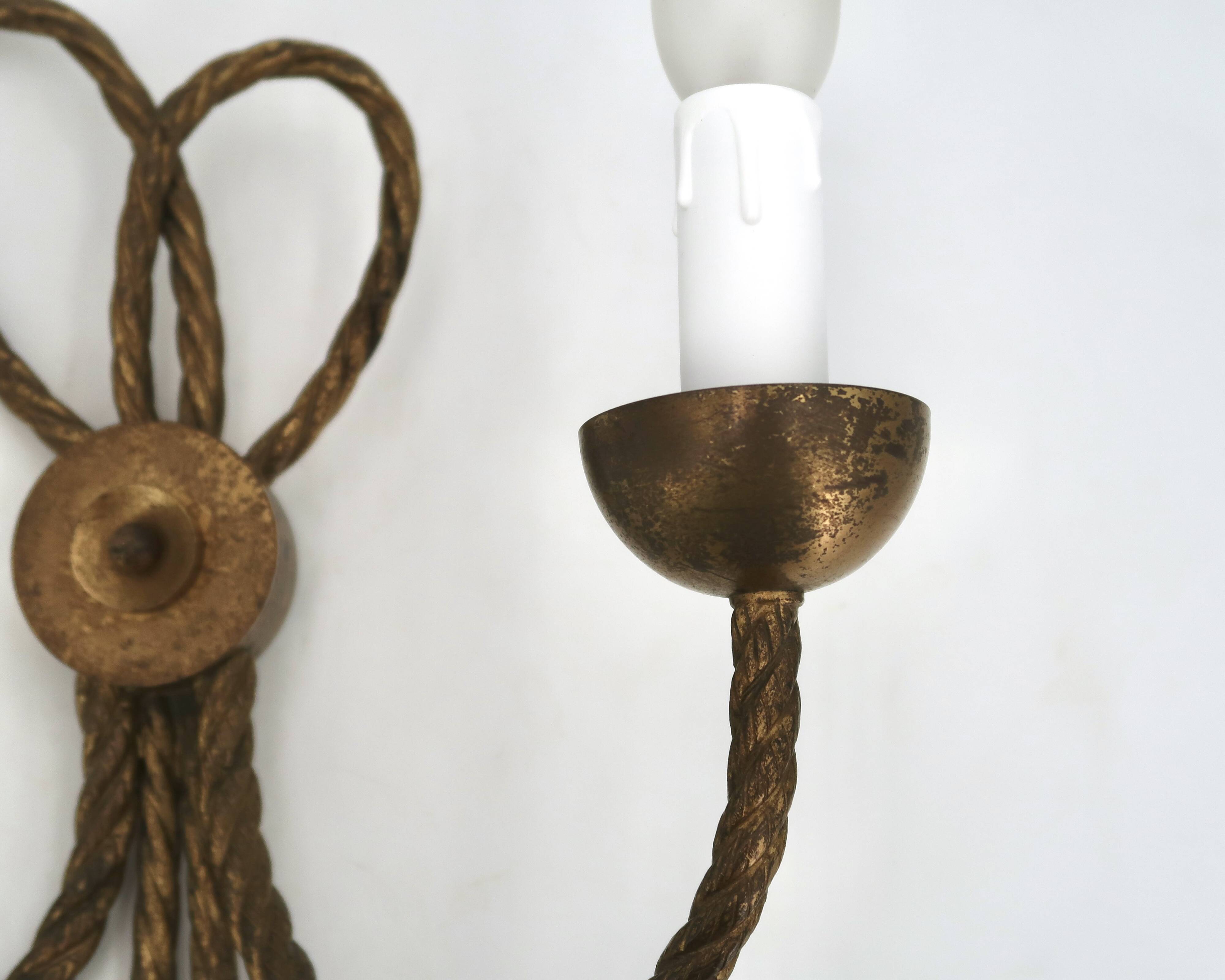 Golden wall lamp with two arms, decorated with a twisted rope bow, 1950s.