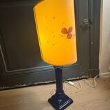 Corinthian column lamp base in blue with a lampshade of dried flowers.