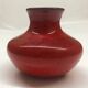 Red ceramic ball vase signed A