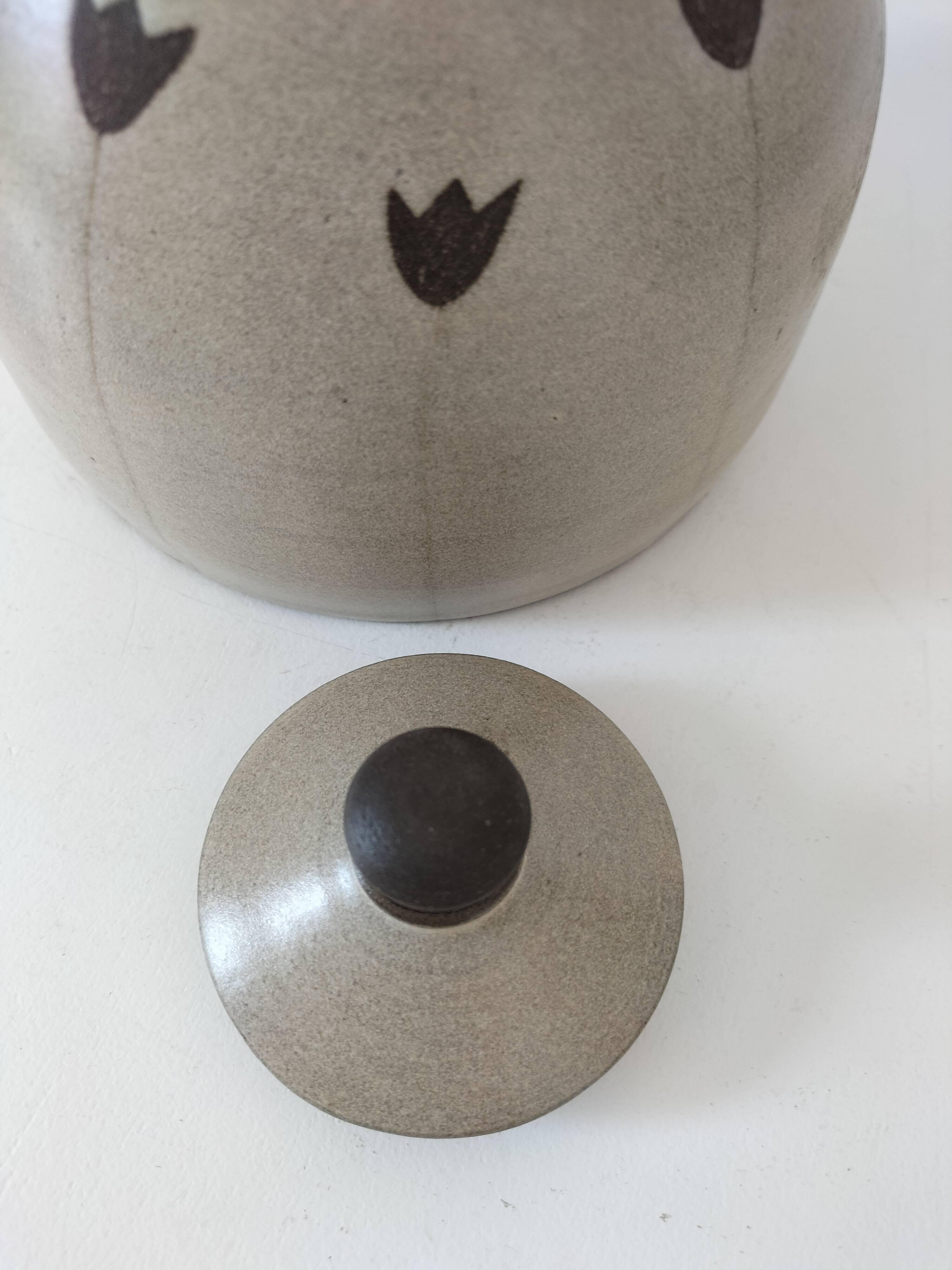 Beige stoneware teapot with stylized flowers and rattan handle