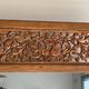 Very large freestanding teak mirror with an openwork carved pediment, Indonesia.