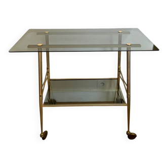 Vintage brass and smoked glass dessert trolley on wheels.