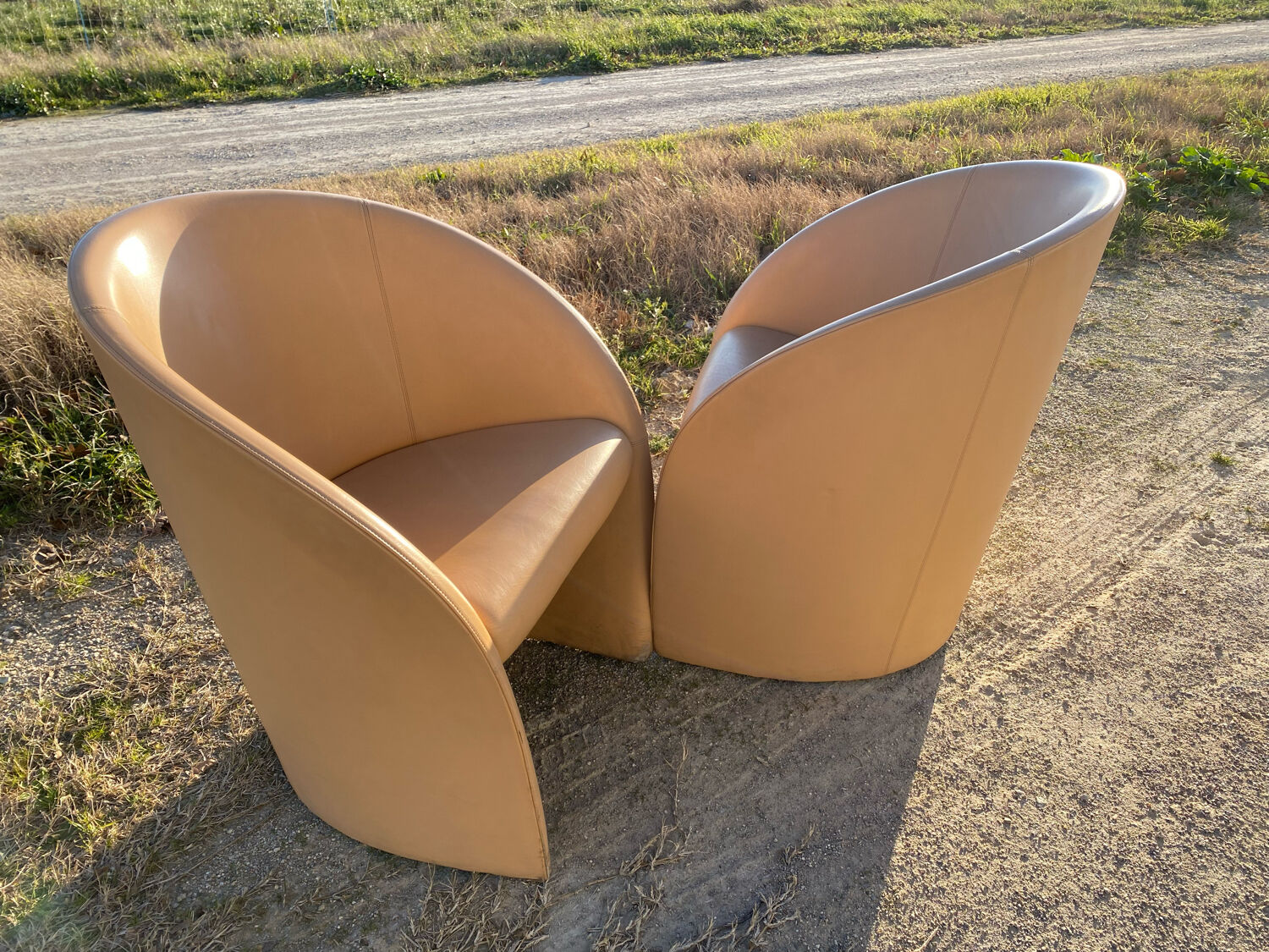 Pair of designer leather armchairs