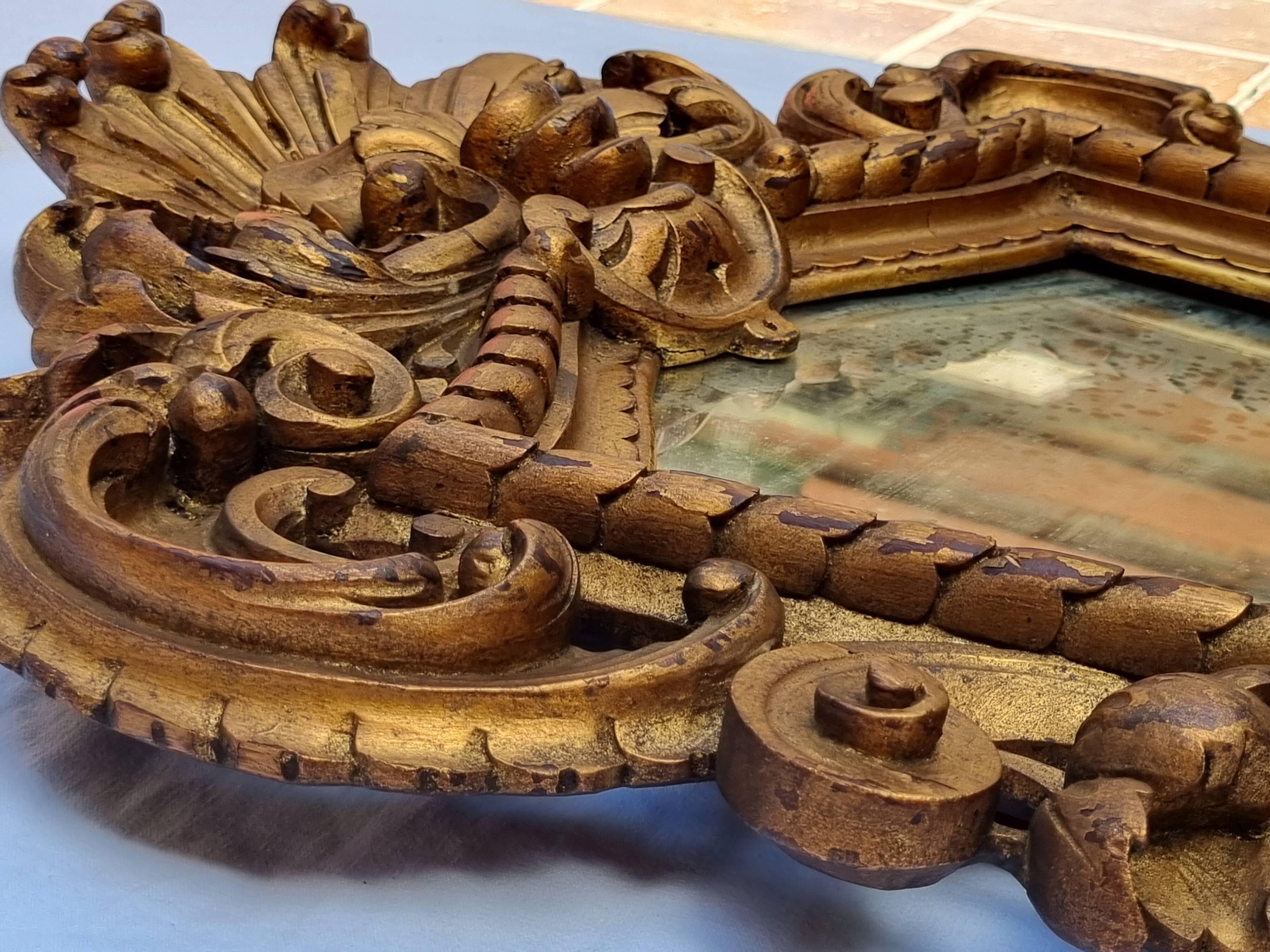 Antique wall mirror in carved gilded wood, Louis XV style, 19th century, 98 x 57 cm.
