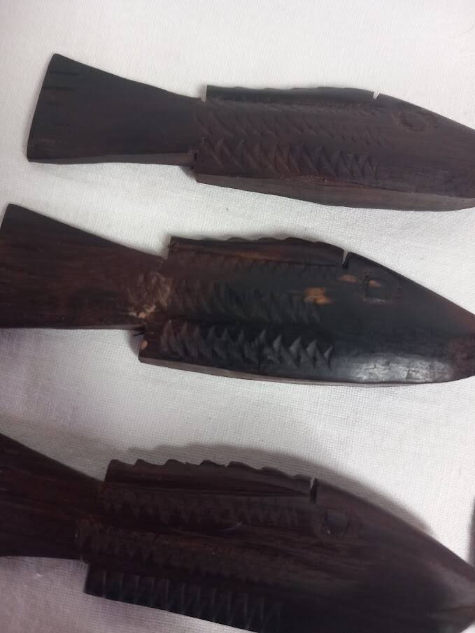 Antique wooden knife rests.