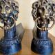 Pair of antique fire dogs with lion heads - patinated cast iron