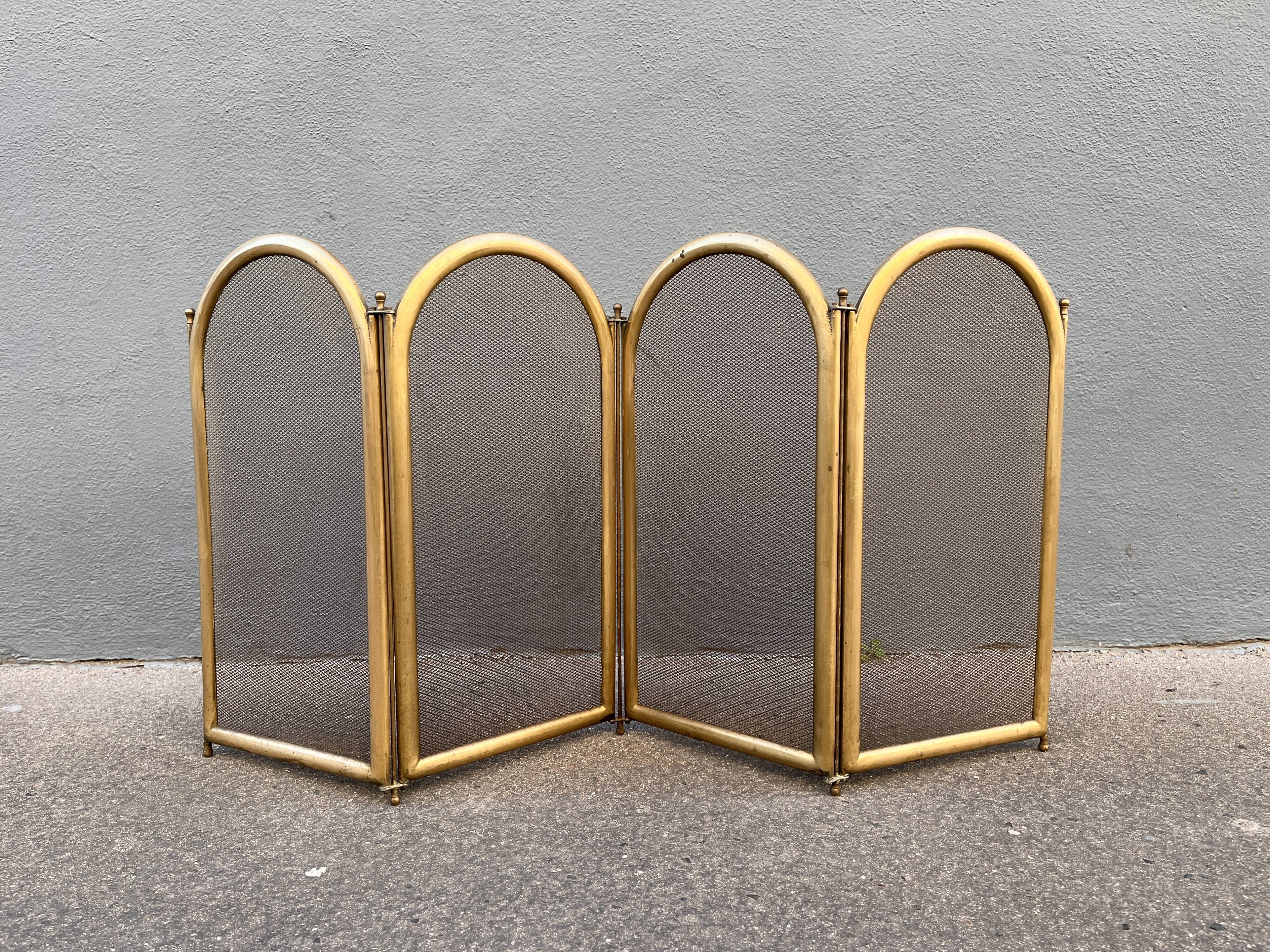 Antique brass fireplace screen from 1920, vintage spark guard.