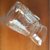 Old glass water pitcher with white flowers in relief with gold edging
