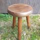 Old vintage wooden tripod milking stool