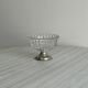 Thick glass bowl on a metal stand.