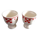 2 white egg cups with red tiles