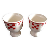 2 white egg cups with red tiles