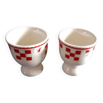 2 white egg cups with red tiles