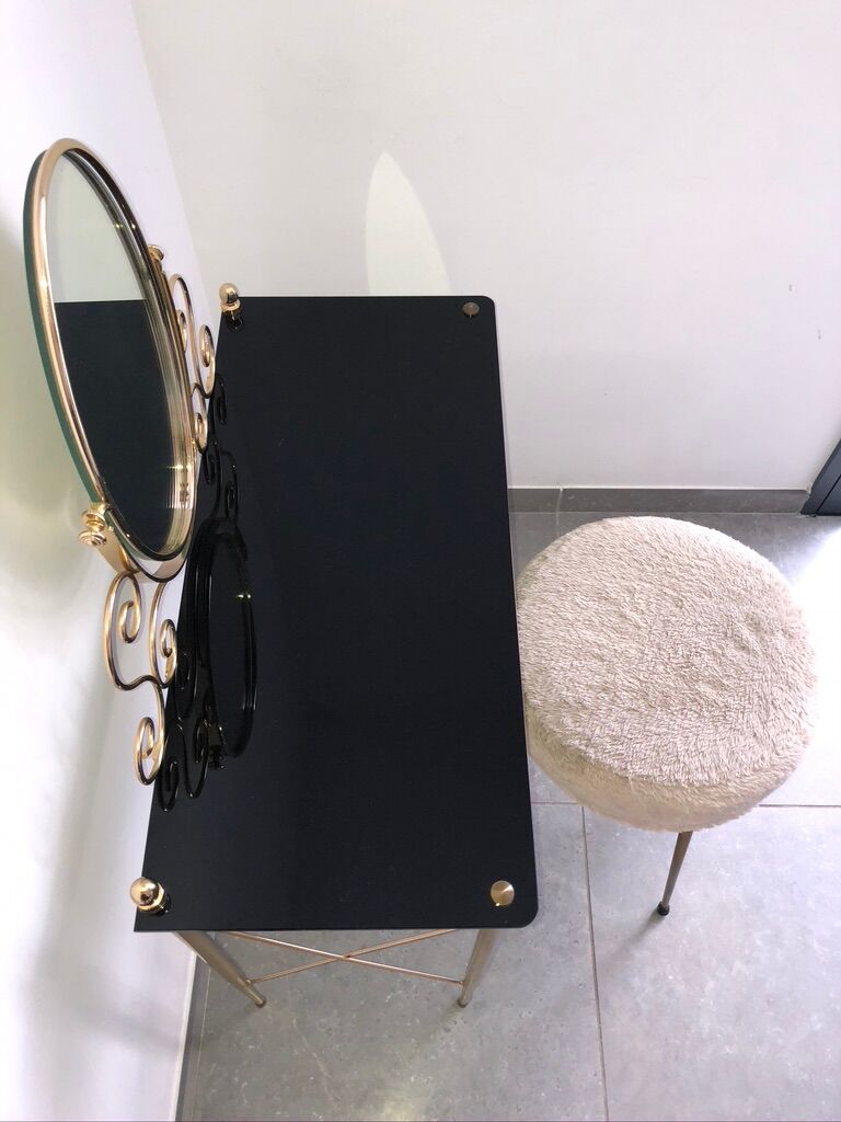 Brass hairdresser, glass and black plastic with its fluffy stool.