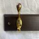 Wooden coat rack with double brass hooks