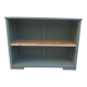 Vintage workshop furniture transformed into a re-enchanted bookshelf in smoky green.