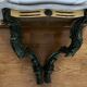 Carved wooden console and gray marble