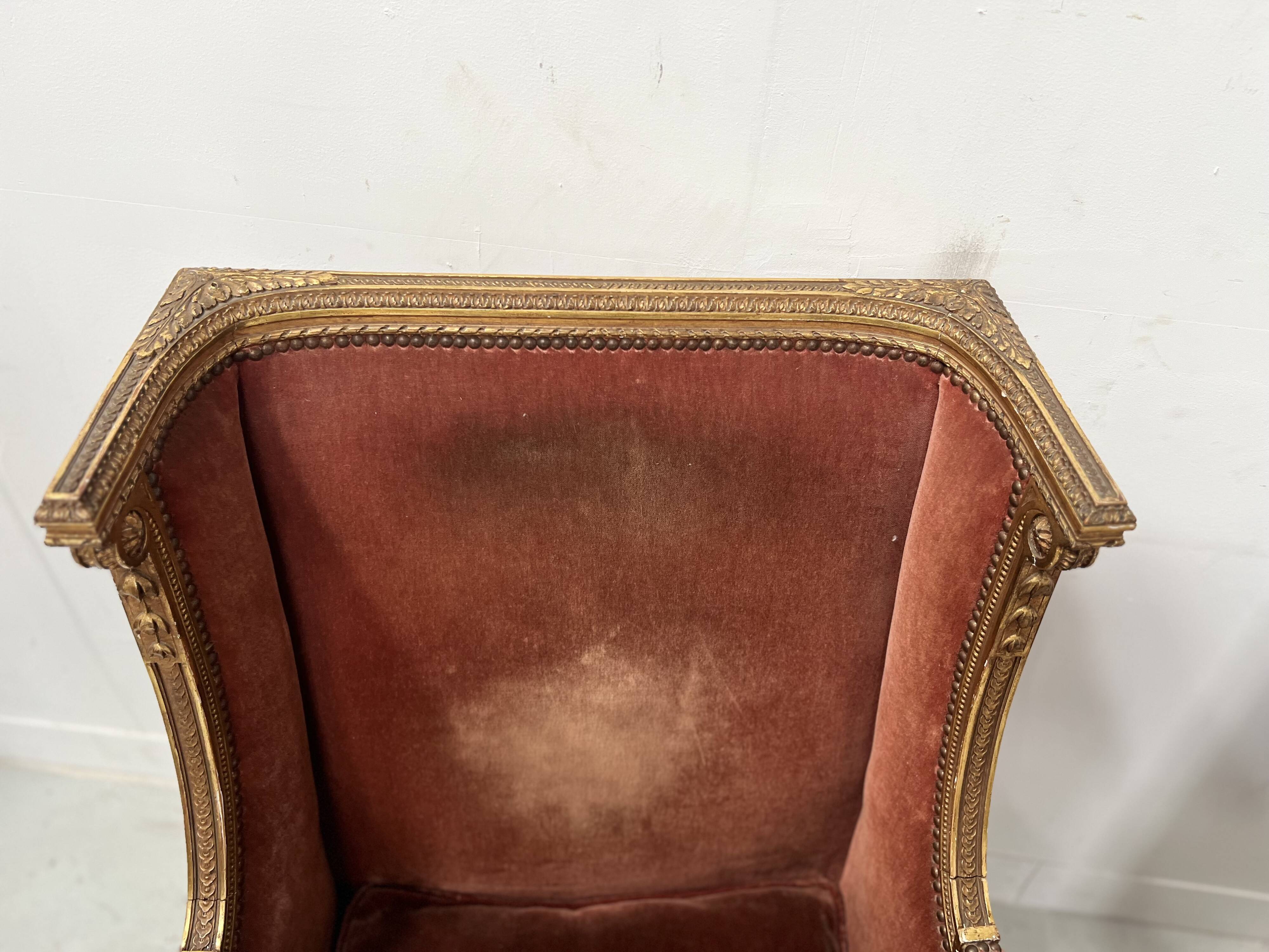 Two Louis XVI style wing chairs in gilded wood, 20th century