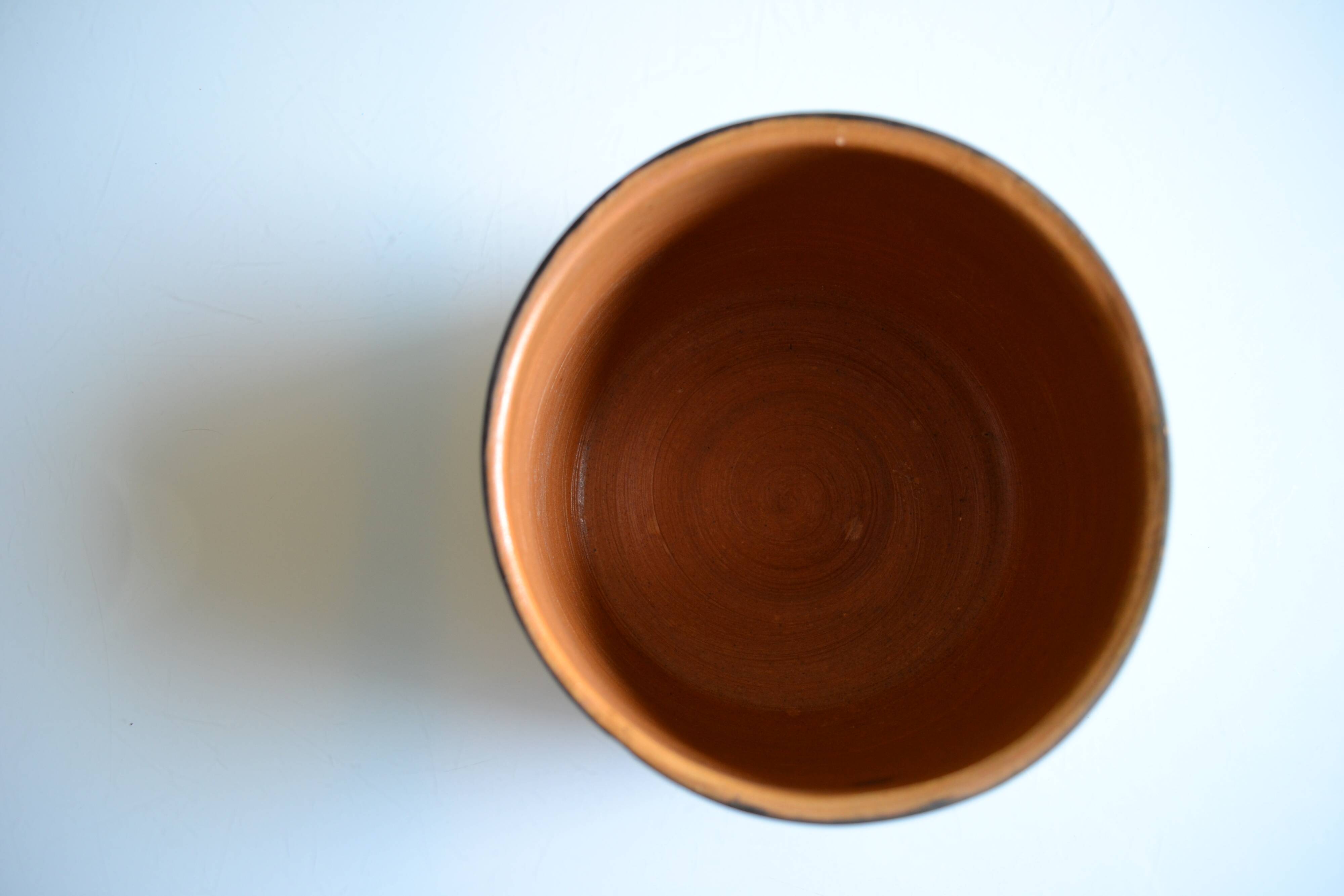 Ceramic cache pot or pocket emptying dish with a signature fish to identify.
