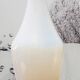Vintage white opaline soliflore vase with blue reflections and twisted foot.