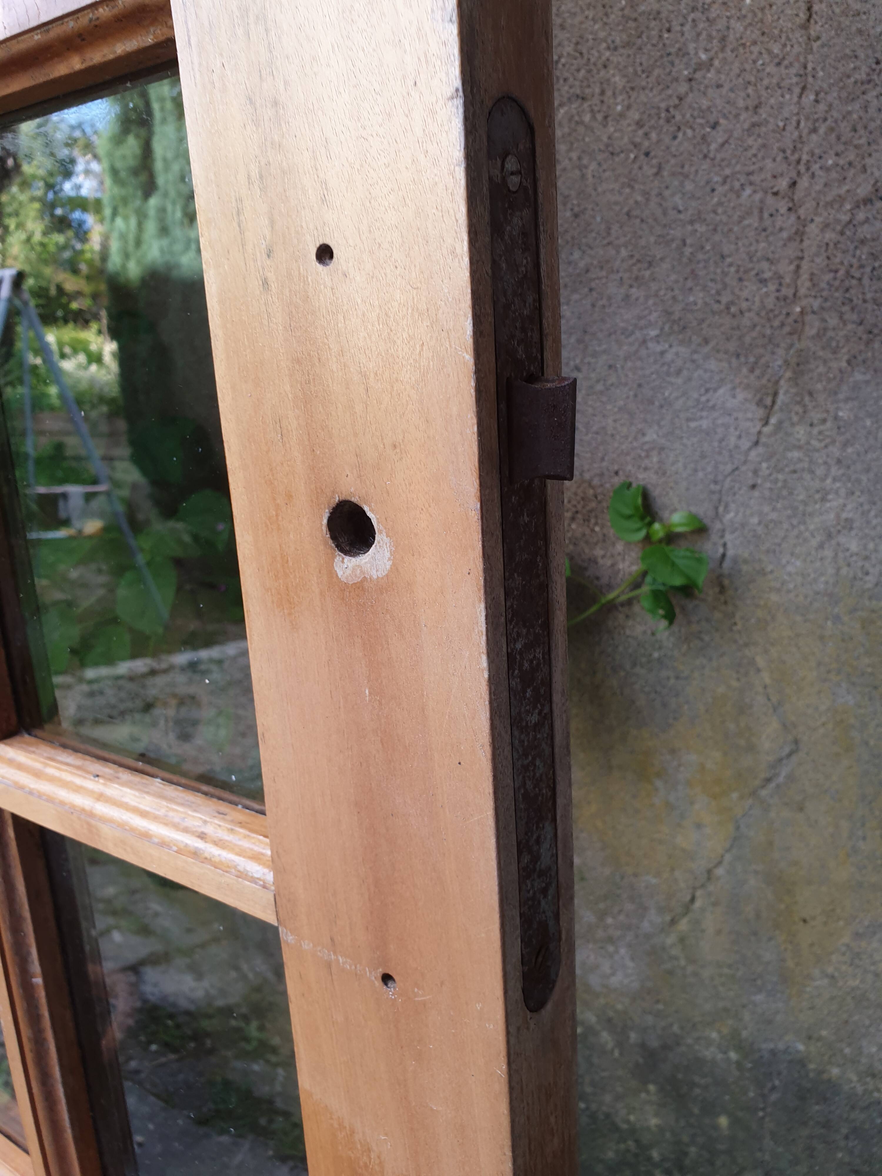 Old wooden door glazed with small tiles