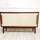 Mid-century teak sideboard with white synthetic doors.