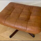 Armchair and footrest in leather