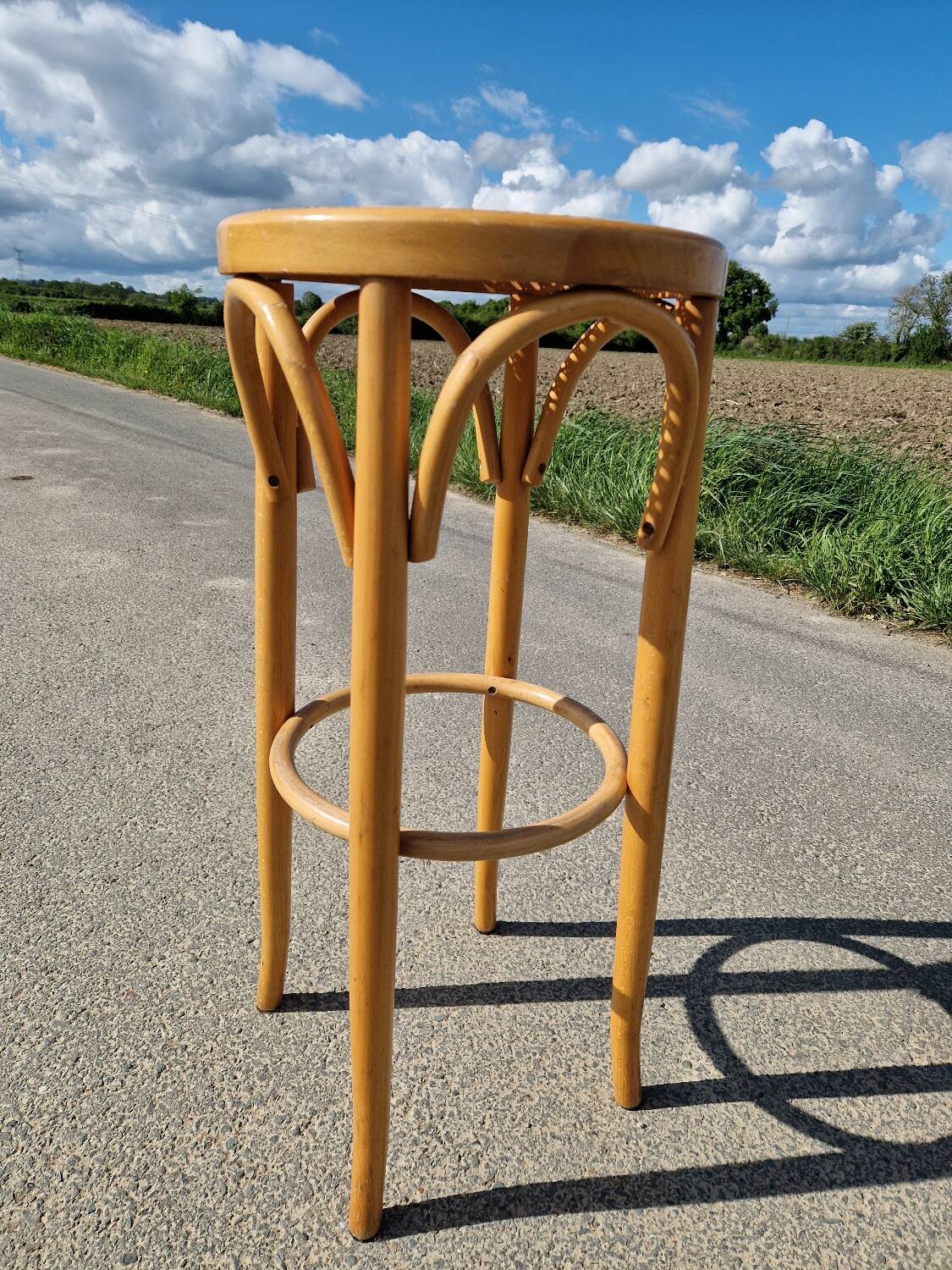 High bar stool in curved wood and cane
