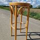 High bar stool in curved wood and cane