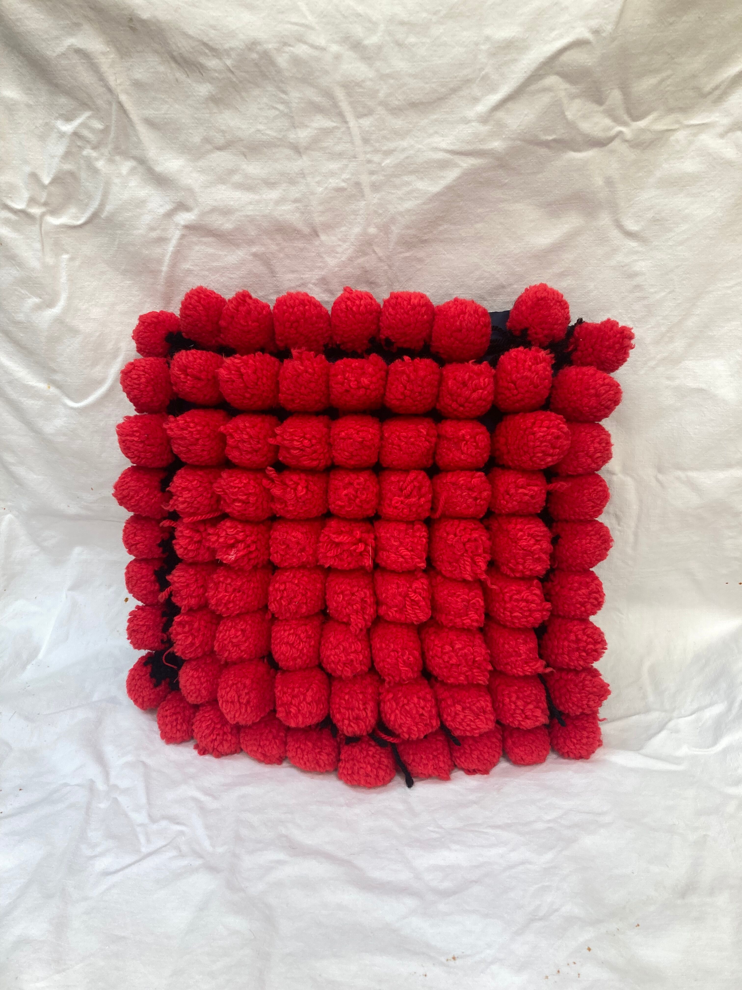 Vintage cushion red pompoms