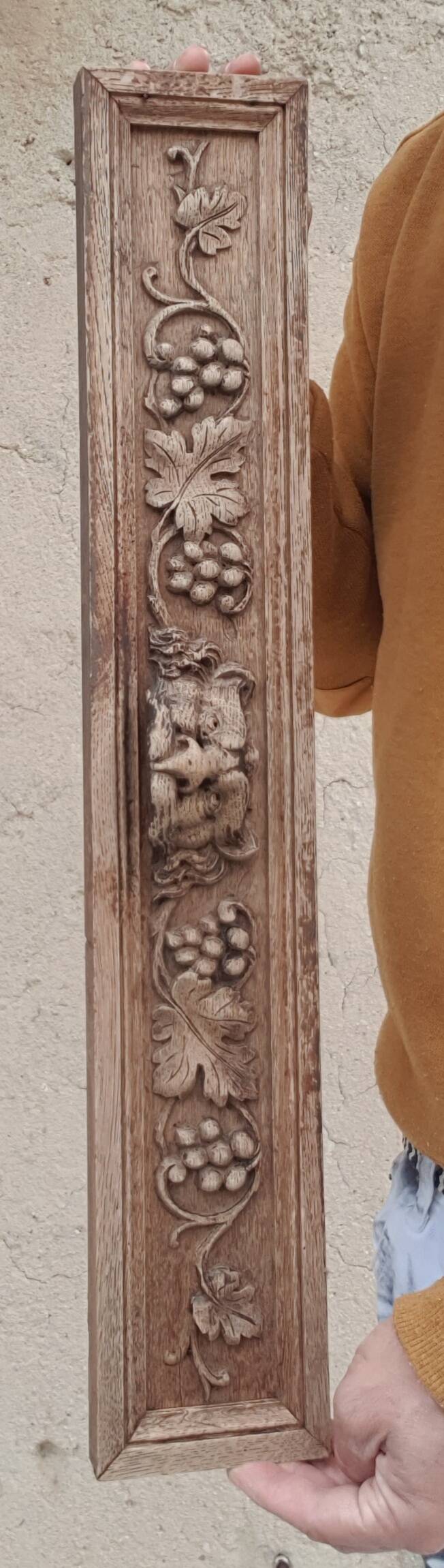 Natural wood pediment with bunches of grapes