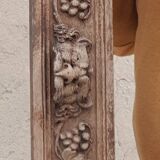 Natural wood pediment with bunches of grapes