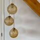 Suspension cascade trois feux globes vintage en verre ambré