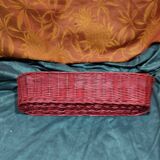 Old bread basket for baguette or red banneton in woven wicker