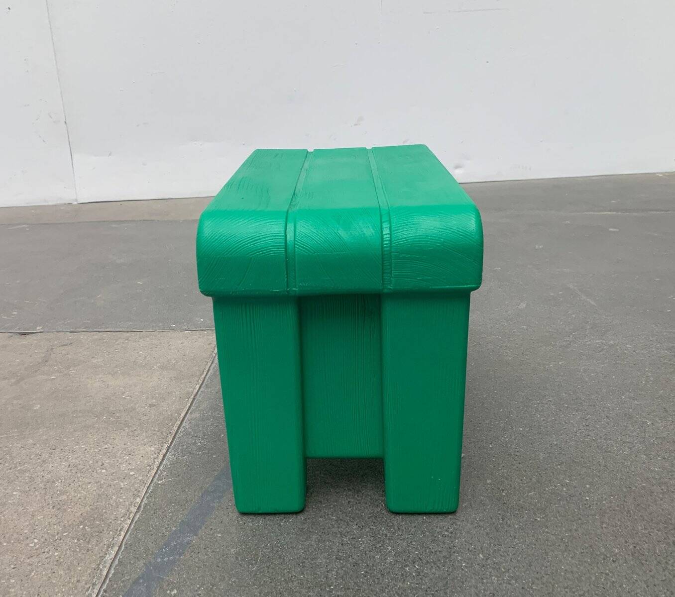 Postmodern plastic stool with a wood effect.