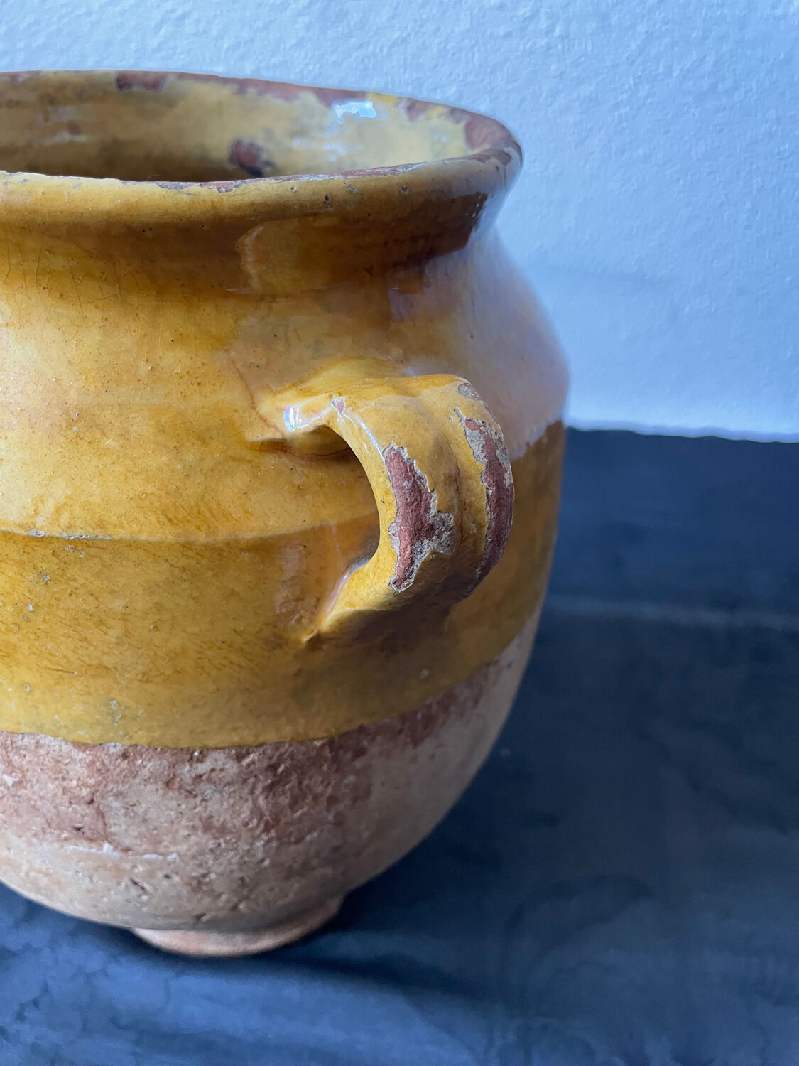 Old candied pot in yellow glazed terracotta