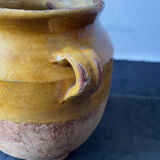 Old candied pot in yellow glazed terracotta