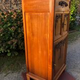 Art Deco sideboard bar cabinet in solid walnut with 3 doors and 1 richly carved tilting false drawer.