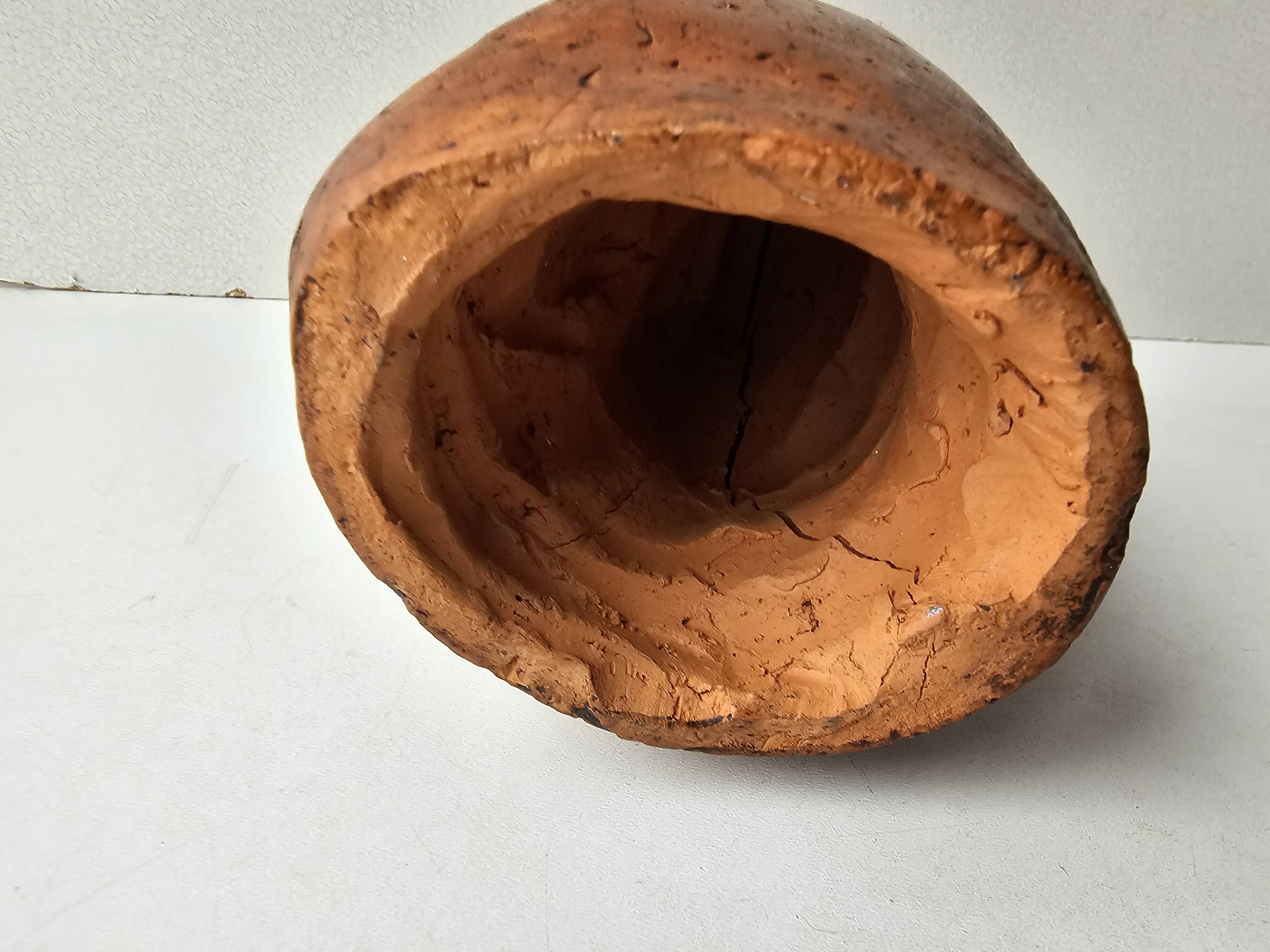 Terracotta face sculpture in African art style