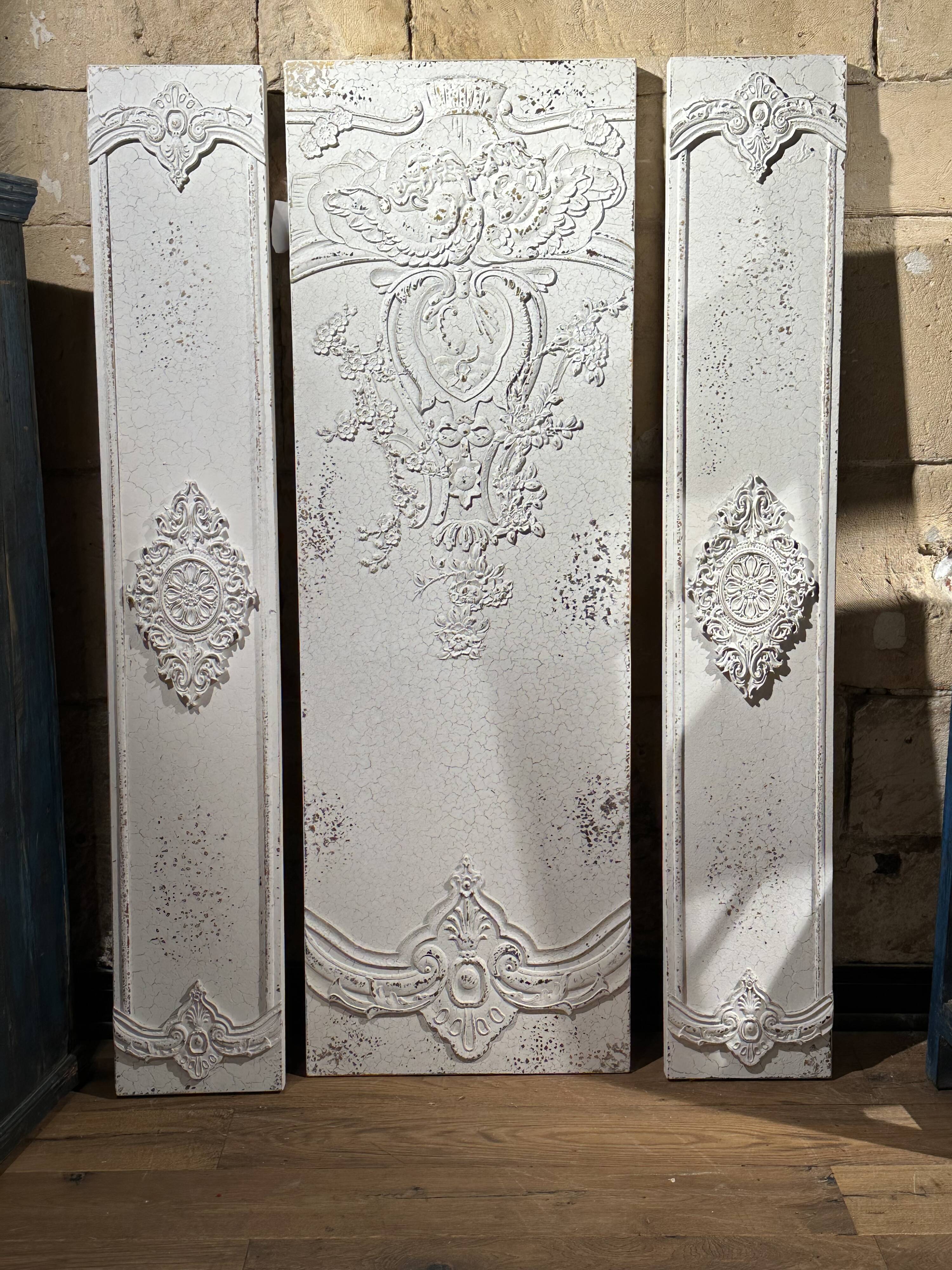 Wall decoration in three pieces, triptych of relief decoration on weathered wood, white and gold,