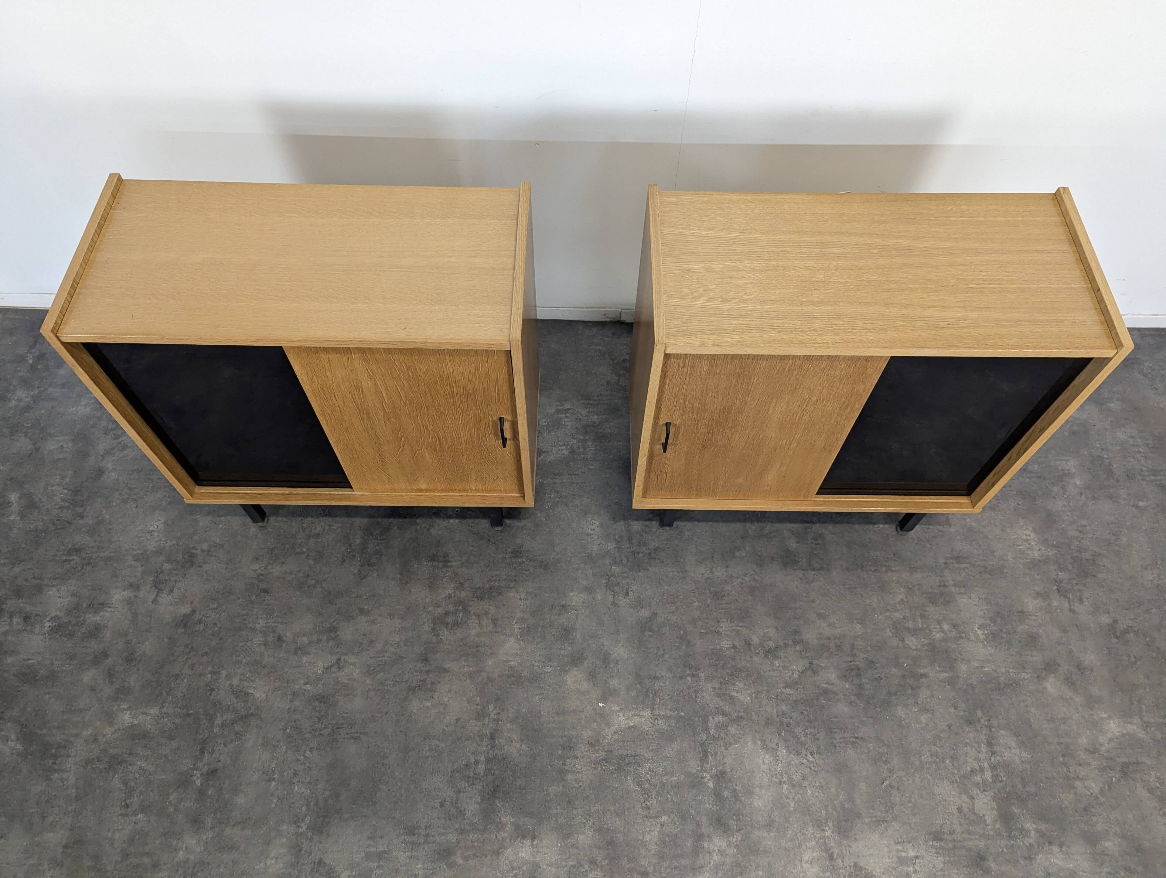 Pair of modernist sideboards with black glass doors in oak veneer.
