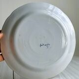 Hand-painted earthenware plate with landscape and bird decoration.