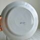 Hand-painted earthenware plate with landscape and bird decoration.