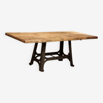 Industrial design table with cast iron base and solid top