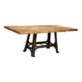 Industrial design table with cast iron base and solid top