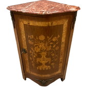 Louis XVI style corner buffet with marquetry decoration featuring a vase of flowers
