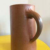 Pitcher in brown sandstone