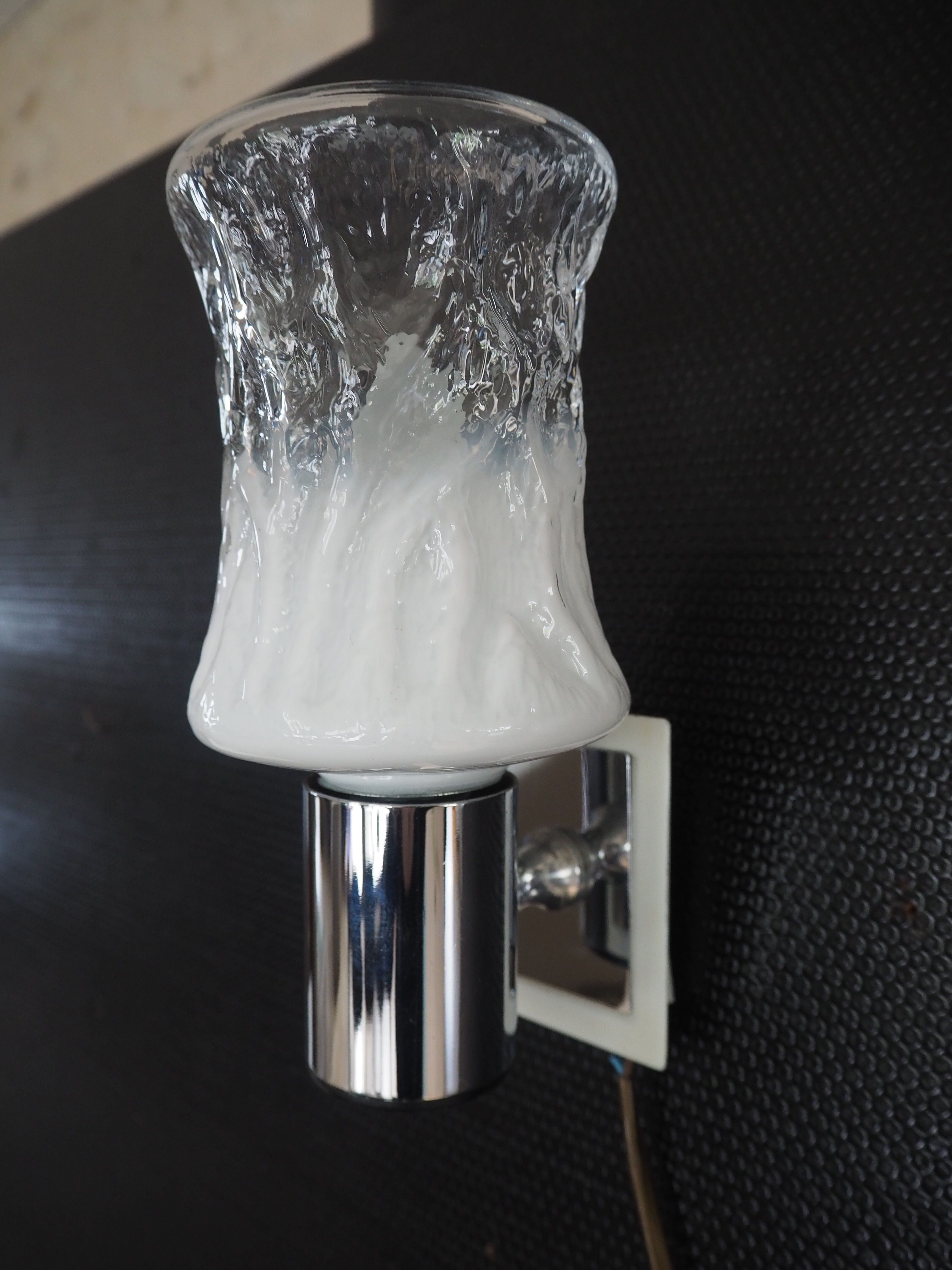 Torch type wall lamp in transparent and white glass