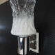 Transparent and white glass torch-type wall light.