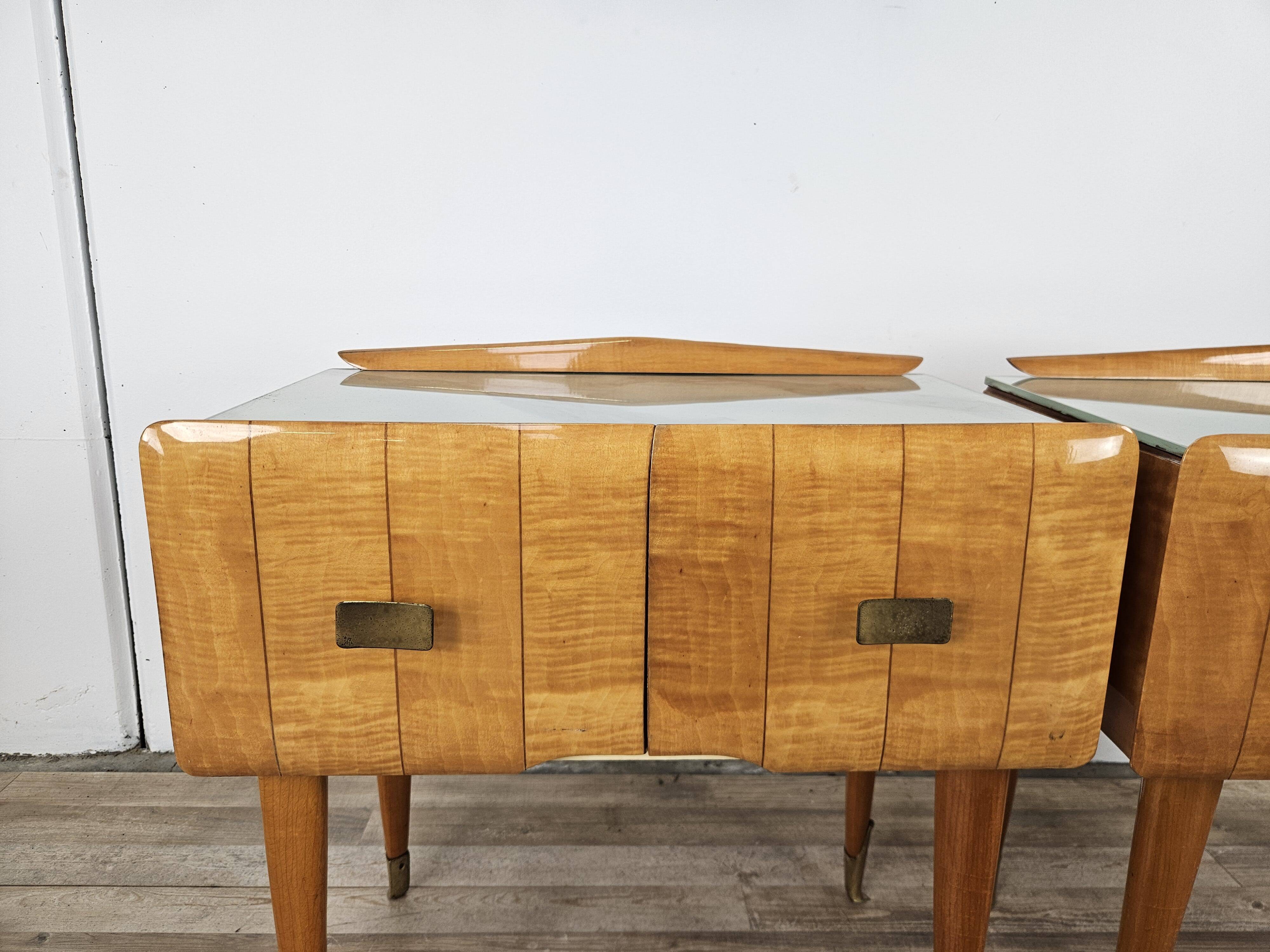 Mid-century nightstands in maple, brass, and glass